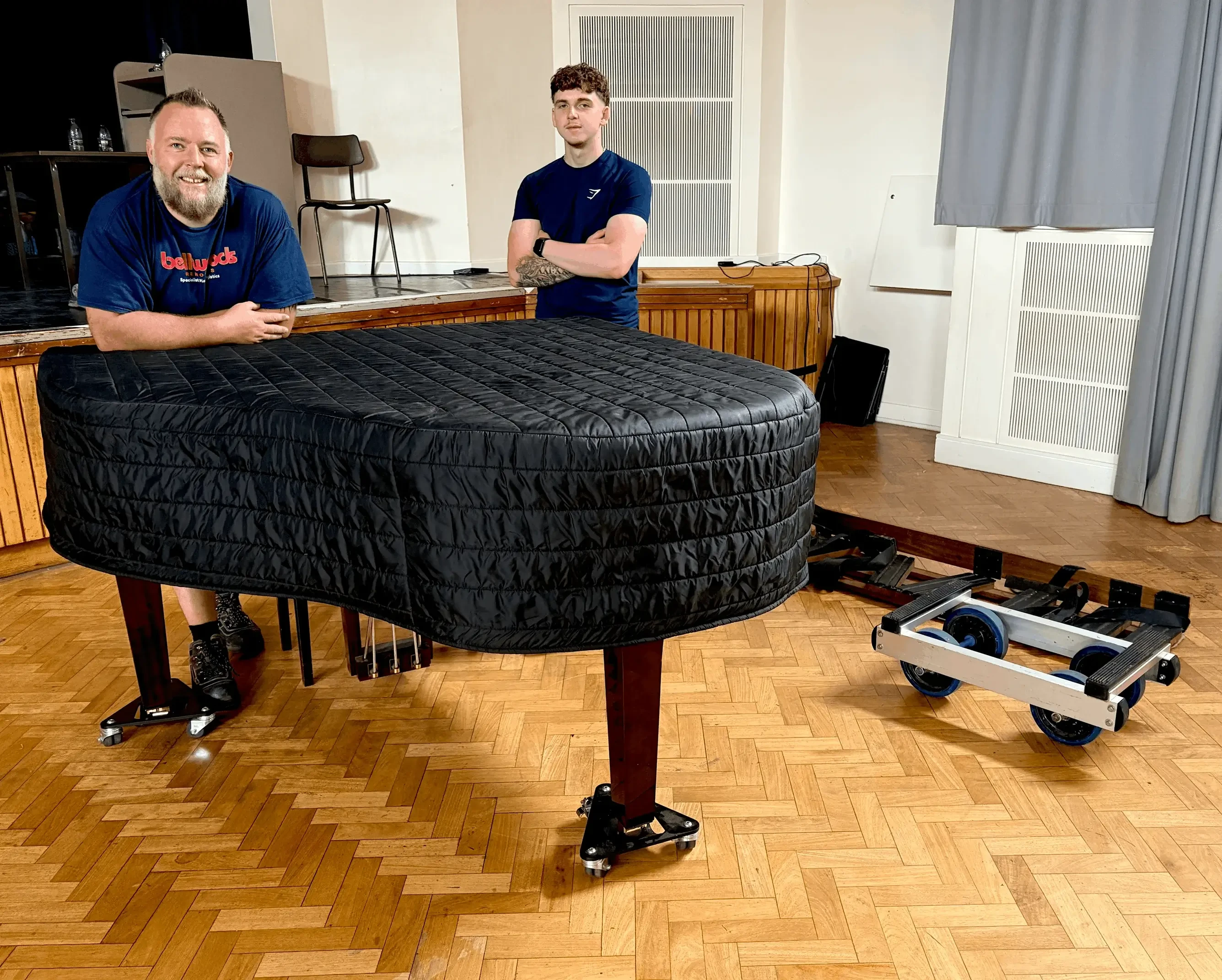 The Piano Removal Leeds team with a grand piano prepared for transport
