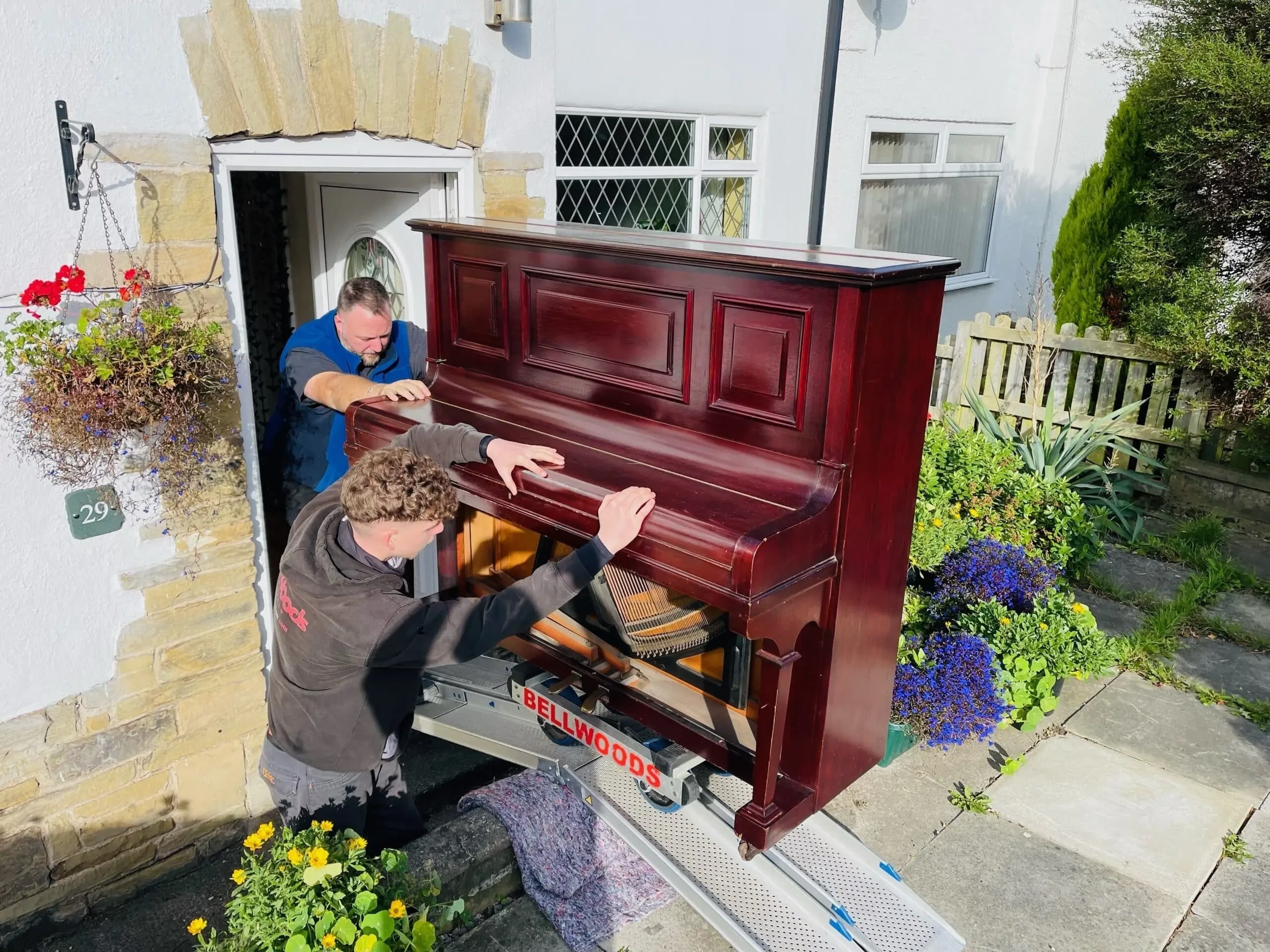 Upright piano carried out of a Yorkshire home on a Bellwoods ramp